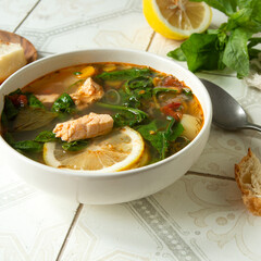 plate with salmon and spinach soup on the table,