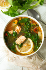 plate with salmon and spinach soup on the table,
