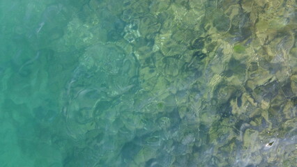 the surface of the sea with a rocky bottom