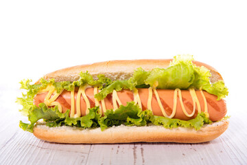 hot dog with sausage, lettuce and sauce