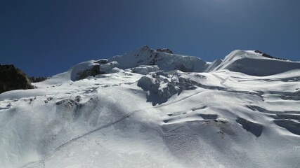 Mountain peak beauty: Climber tracks across summit snow field, Bolivia - Powered by Adobe