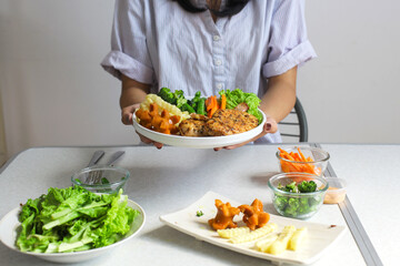 Hands Showing Chicken Steak With Salad