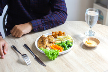 Top View Of Chicken Steak With Salad, Spoon And Fork, And Mayonnaise On Wooden Table
