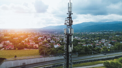 Cellular tower overlooking rural town and highway in mountains