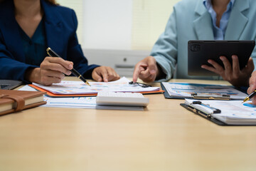 A businessperson  financial analyst during a corporate meeting. review a graph document, discussing financial data and strategies to ensure successful outcomes effective teamwork achieving corporate
