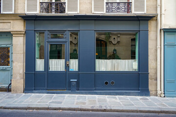 fancy and stylish vintage shop facade , blue painted french boutique storefront