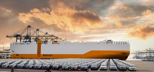 Close up vehicle carrier vessel loading car for shipping to worldwide, Large RoRo (Roll on off) vehicle car carrier, New car lined up in the port for import export around the world.