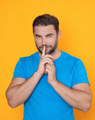 Secret man, isolated. Say hush be quiet with finger on lips, shh gesture. Man keep silence. Shh...