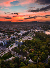 Budapest, Hungary - Aerial panoramic view of the Museum of Ethnography at City Park with Heroes' Square and skyline of Budapest at background with colorful sunset sky over the capital of Hungary