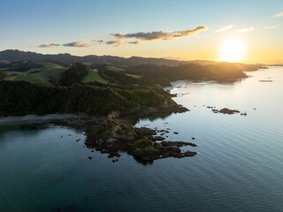 Shoreline of the Firth of Thames at sunset at Orere Point, Auckland, New Zealand.