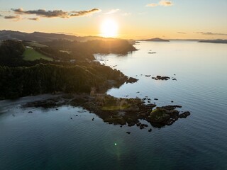 Shoreline of the Firth of Thames at sunset at Orere Point, Auckland, New Zealand.