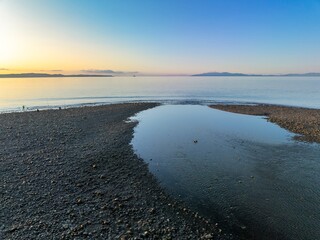 Shoreline of the Firth of Thames at sunset at Orere Point, Auckland, New Zealand.