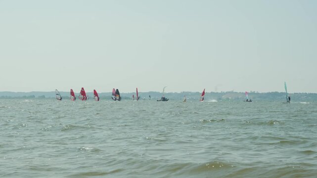 Windsurfers having fun in a light breeze. Watersports on the Baltic Sea, Poland