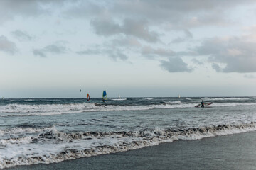 Canary Island, Tenerife-December14,2023.Man professional surfer standing on the sandy beach with...