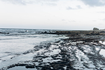 Man professional surfer standing on the sandy beach with his kite and board. Windsurfing, Extreme Sport