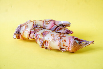 Lengkuas or known as galangal rhizomes isolated on yellow background