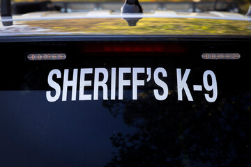 Signs warning that a K-9 dog is in a Sherriff's vehicle