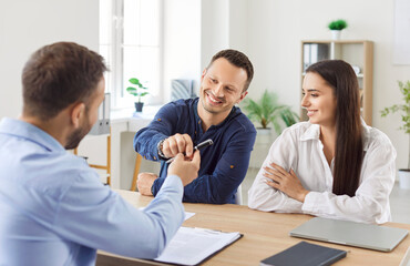 Family couple, as customers, signing a contract with a financial consultant or investment agent...