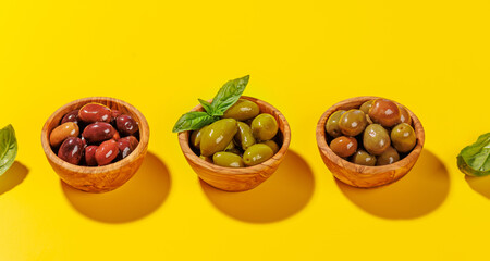 An assortment of various olives presented in a bowl, showcasing different colors, textures, and flavors