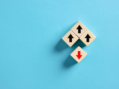 Red arrow going opposite way of black arrows on wooden cubes