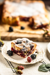 Fresh and hot blackberry cake made of blackberries, flour and eggs. Vegan fruit sponge cake