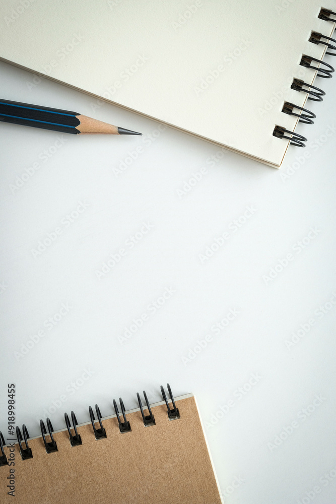 Wall mural open blank spiral notebook with black pencil on white background. empty space for your text.