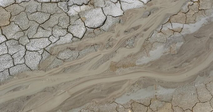 Muddy Vulcanos located in Buzau County, Romania, a National Landmark, Gas bubbles coming out a mud volcano. Paclele mici and Paclele Mari