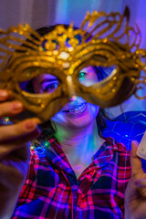 Golden mask on the background of a girl