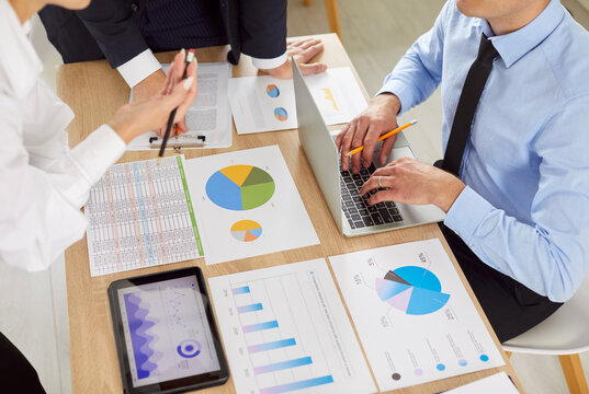 Finance marketing research reports paper close up, economic sales statistics documents lying on office desk, business people planning organization process