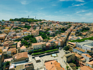Naklejka premium Aerial view of little town of Sant'Antioco houses at sunrise in italy