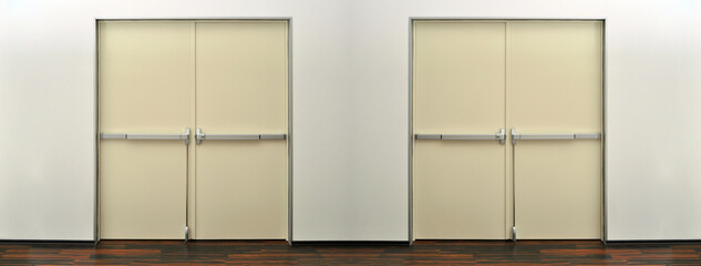 Emergency exit grey or beige two door. Push bar and rail for panic exit