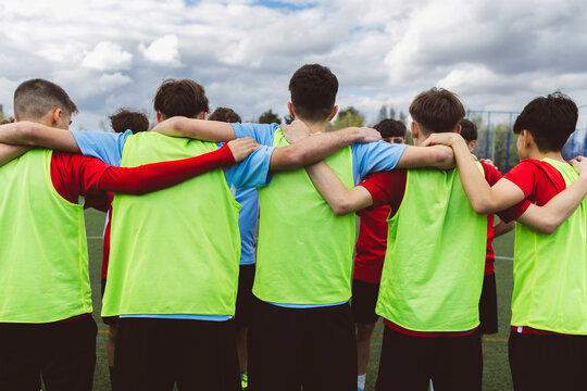Soccer players huddling under cloudy sky