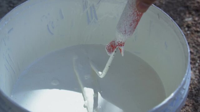 Slow motion paint roller is dipped in paint to apply paint concept to paint walls or paint the interior and exterior of the house.