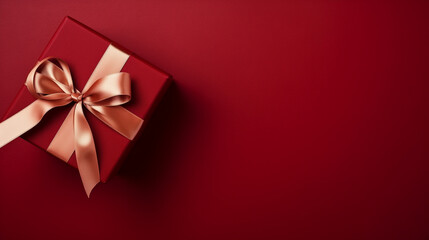 A vibrant red gift box adorned with a satin bow rests elegantly on a rich red background, exuding a festive and celebratory ambiance, copy space