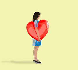 Woman standing with red heart balloon against yellow background