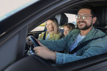 Happy family enjoying trip together by car, view from outside