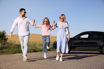 Parents, their daughter and car outdoors. Family traveling