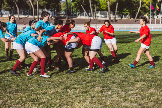 Rugby players in scrum on field