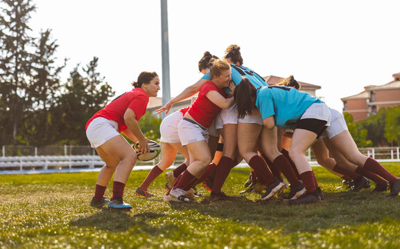 Rugby players in scrum on sunny day