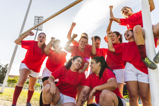 Athletes cheering and celebrating victory on rugby field