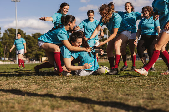 Rugby players playing on sports field