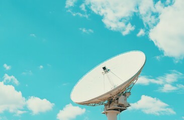 A white satellite dish against the blue sky, symbolizing advanced communication technology and global connectivity.