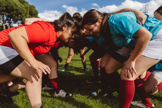 Rugby players in scrum on sports field