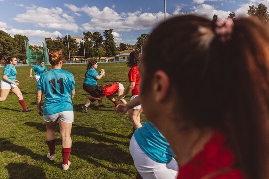 Rugby players having team match on field