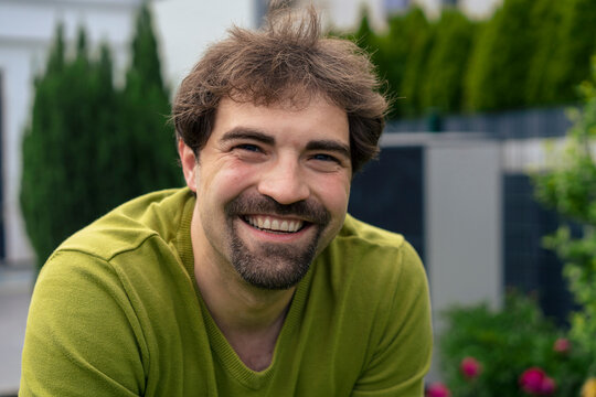 Happy man with goatee in back yard