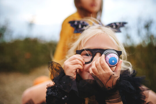 Girl wearing glasses with bulging eye in field