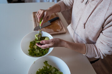 Preparing Fresh Green Salad in the Kitchen