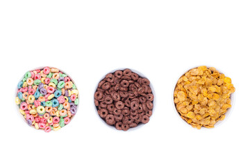 Three bowls of cereals on white background top view.