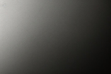 マットグレーの滑らかなプラスチックの表面に細かい質感があり、右側にビネットが付いています。絶妙なテクスチャ背景、柔らかい空白の背景	