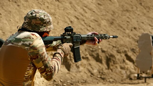 Man with military background fires at two targets with precision and smooth movements during tactical training at a shooting range. Perfect for action, military, and firearms-related content.